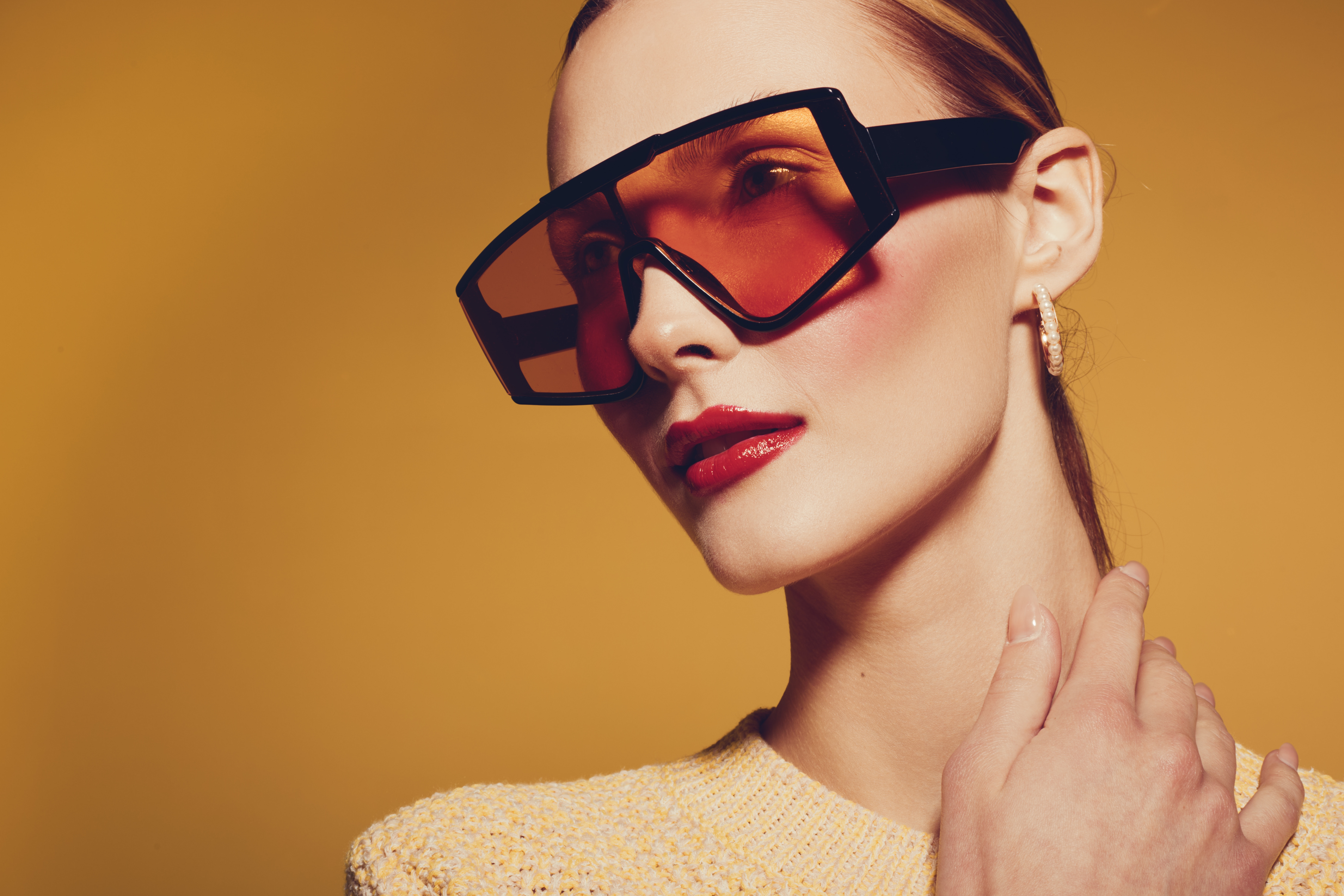 Model wearing bold designer eyewear, representing the Kresloff Eye Associates optical boutique